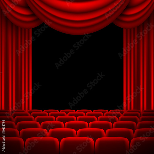 an auditorium with a red curtain