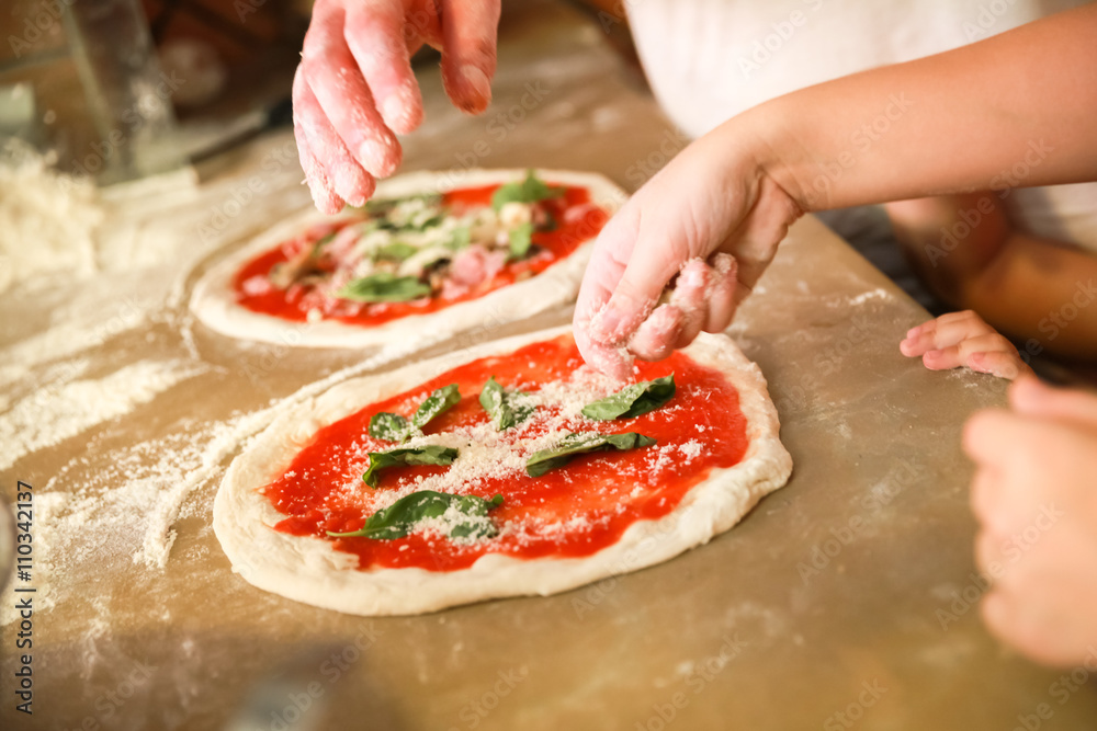 Preparing Pizza Margherita. Cooks hands - obrazy, fototapety, plakaty 