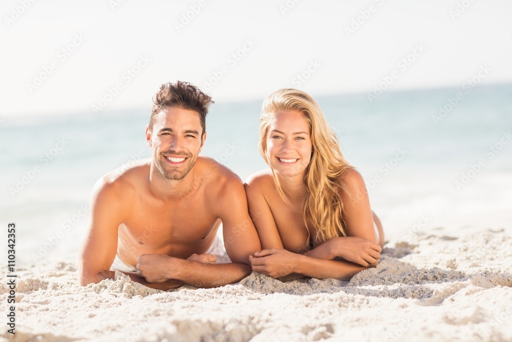 Young couple lying on sand