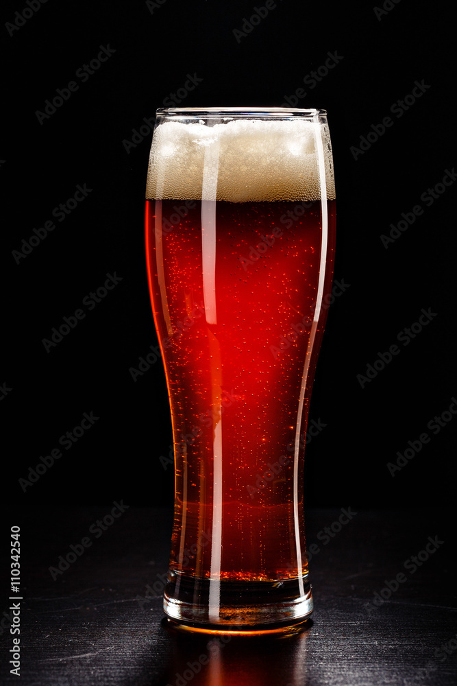 Beer Glass with DROPS on black. FRESH! MUCH FOAM! Beer bubbles closeup. DRAFT. Overflow beer glass. Beer beverage. Glass of alcohol. Closeup Cold Beer. Pint of beer. Good for brewery commercial