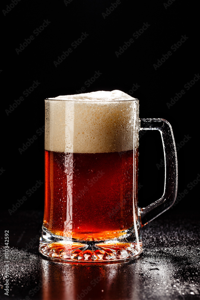 Beer Glass with DROPS on black. FRESH! MUCH FOAM! Beer bubbles c