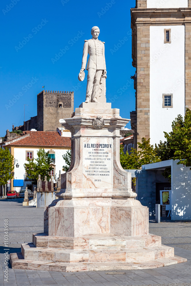 Dom Pedro V Square in Castelo de Vide. Dom Pedro V statue with Santa Maria da Devesa church in the back. Alto Alentejo, Portugal