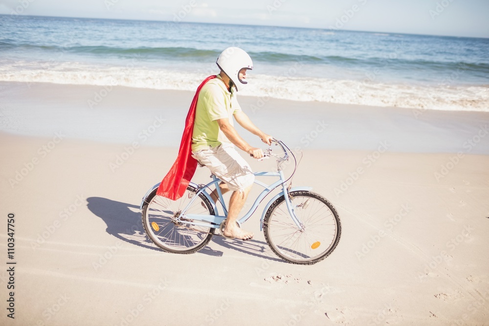 Fototapeta premium Senior superhero riding bike