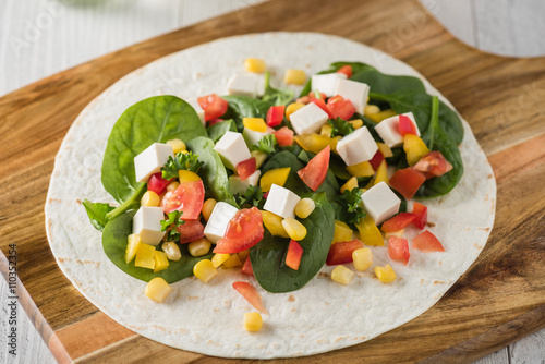 vegan tofu wraps with pepper, corn, tomatoes and spinach