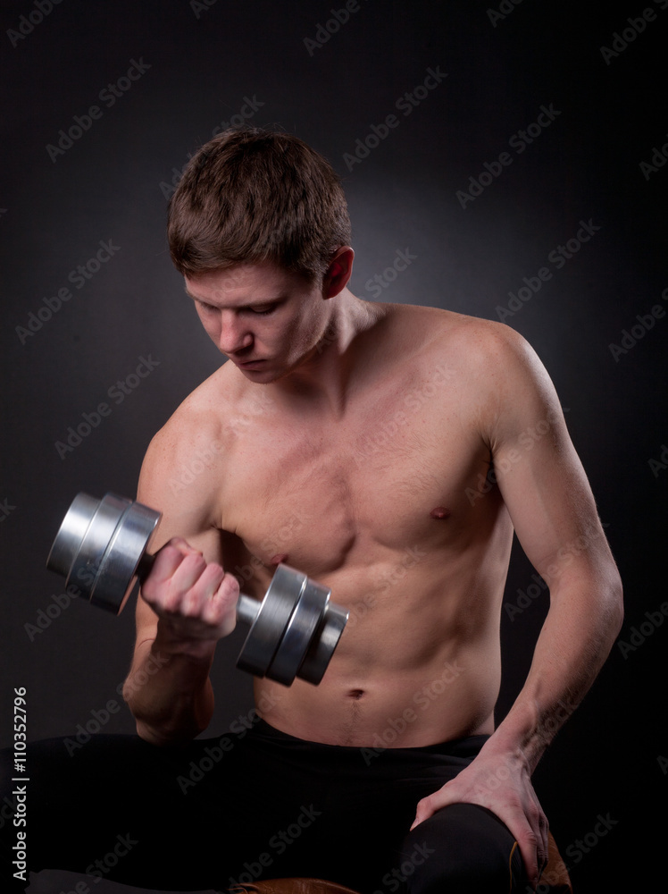 Muscular man with dumbbell