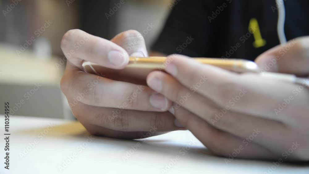Unknown Asian male use smartphone with touch screen to chat and contact people full HD. Unknown Asian male use smartphone with touch screen to chat and contact people full HD.