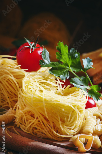 Nests Italian dry pasta, aasorti different kinds of pasta, parsl