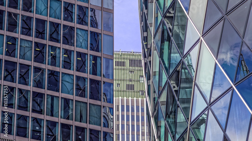 Peaking through a Cityscape of Modern buildings in London reflecting one another