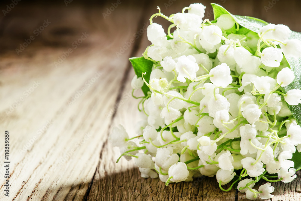 Bouquet of may forest lily of the valley, vintage wooden backgro Bouquet of may forest lily of the valley, vintage wooden backgro