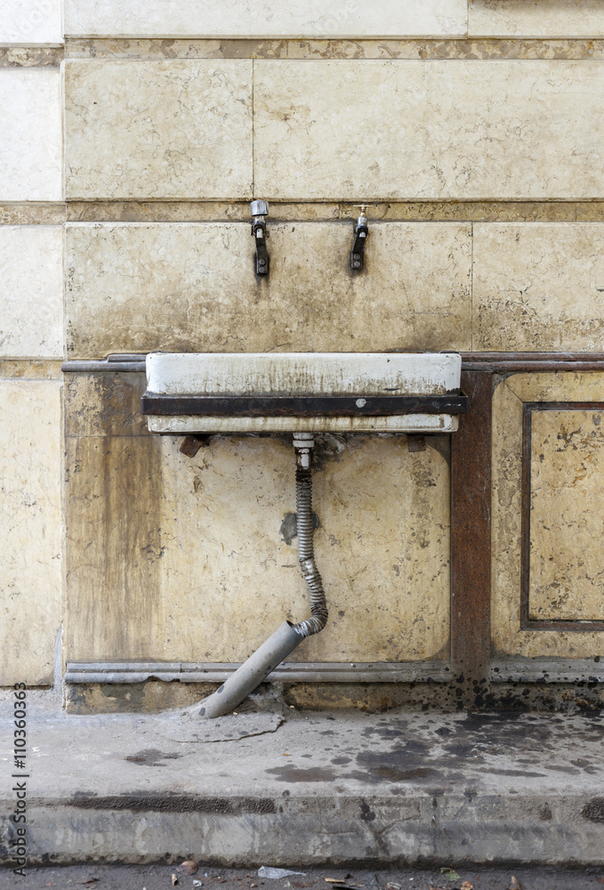 Public sink in street. Public sink in street.