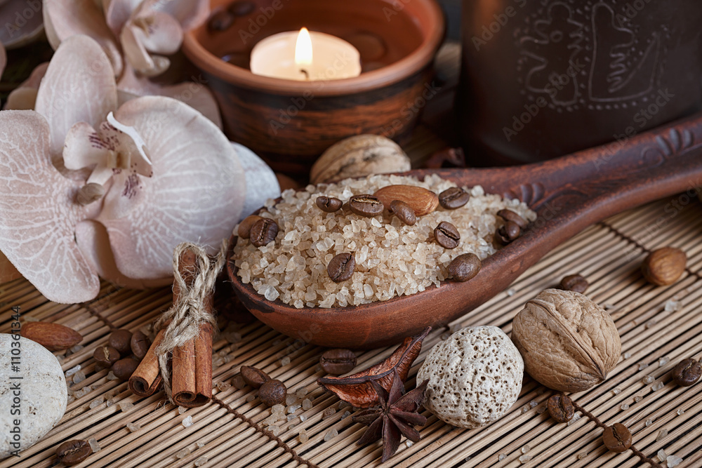 Naklejka premium SPA concept: natural sea salt with coffee beans, cinnamon and an