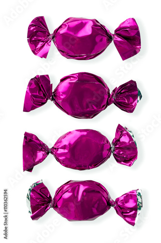 view of purple shiny candies arranged side by side. © Dan Kosmayer