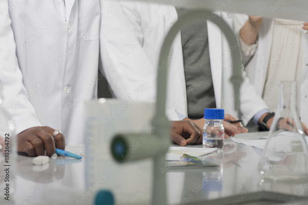 Group of young medical workers are working in lab as lab technicians