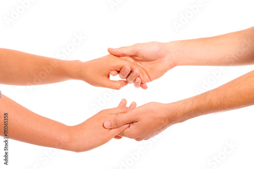 Close-up of a woman and a man holding hand in hand on a white background