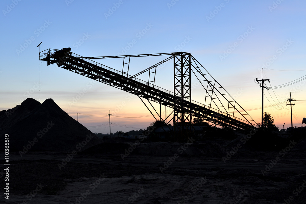 Sand mining with silhouette sunset sky