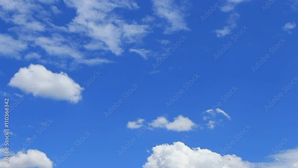 Time Lapse, motion white, gray, puffy clouds on the background blue sky Time Lapse, motion white, gray, puffy clouds on the background blue sky