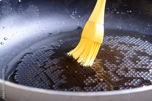 Obraz na plátne Greasing pan by silicone brush