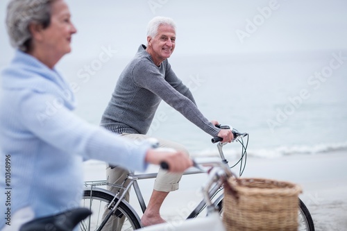 Senior couple having ride with their bike