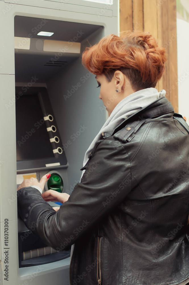 Business woman taking money from ATM Business woman taking money from ATM