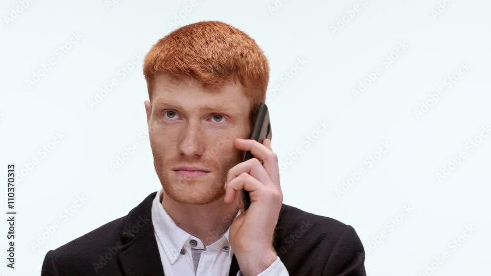 Handsome redhead man talking on phone. Close up. Slow motion