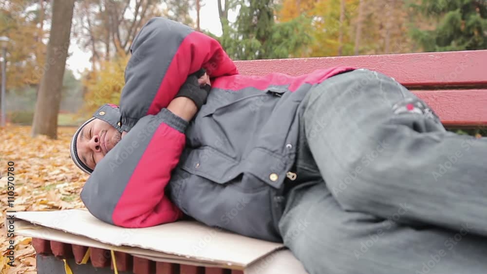 Male addicted to alcohol sleeping on bench, drunk man suffering from hangover