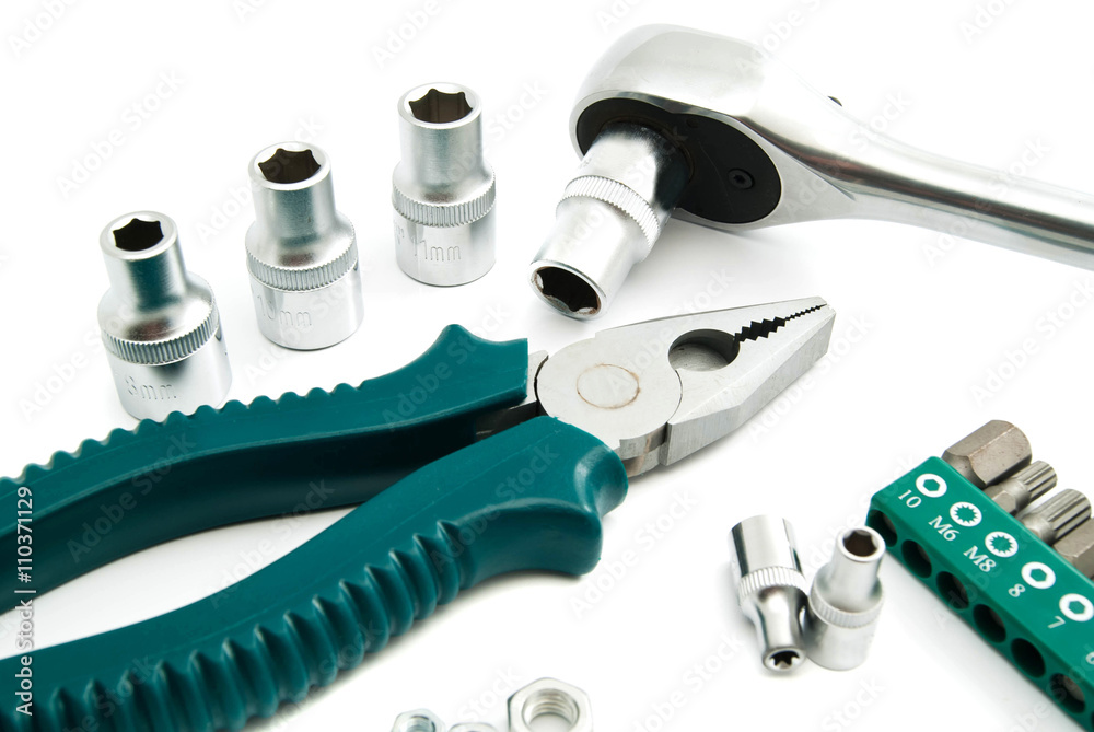 pliers, heads and ratchet on white pliers, heads and ratchet on white