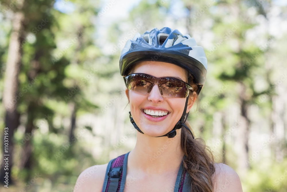 Portrait of happy woman wearing helmet at forest Portrait of happy woman wearing helmet at forest