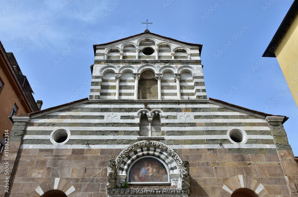 San Giusto medieval church in Lucca. Detail of romanesque upper part of the facade with typical white and black stripes decoration and double loggia