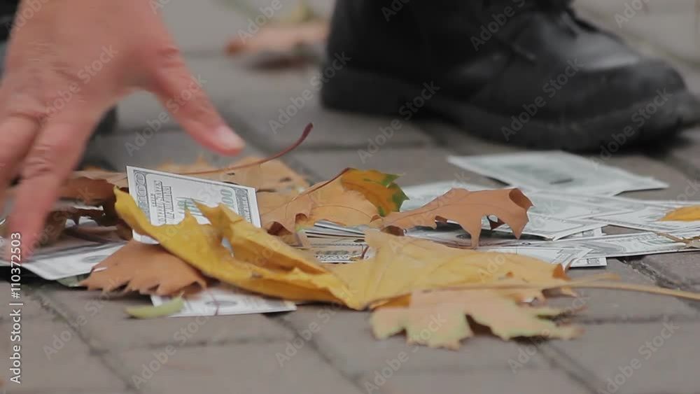 Street cleaner sweeping dollar banknotes in city street, money losing value Street cleaner sweeping dollar banknotes in city street, money losing value
