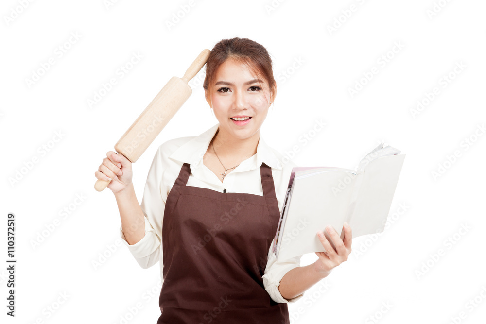 Asian Baker woman in apron with wooden rolling pin and cook bo Asian Baker woman in apron with wooden rolling pin and cook bo