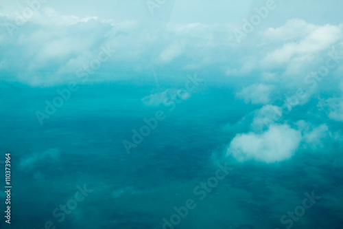 Clouds and turquoise water, flying in Belize © karagrubis
