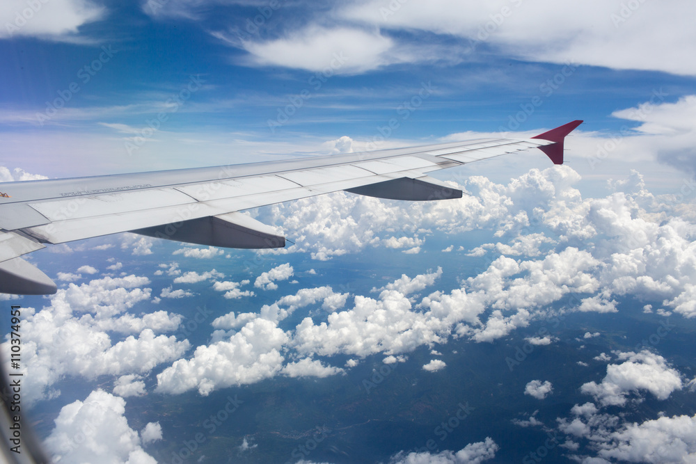 Above the clouds.Wing aircraft in the sky under earth of Bali,Indonesia Above the clouds.Wing aircraft in the sky under earth of Bali,Indonesia