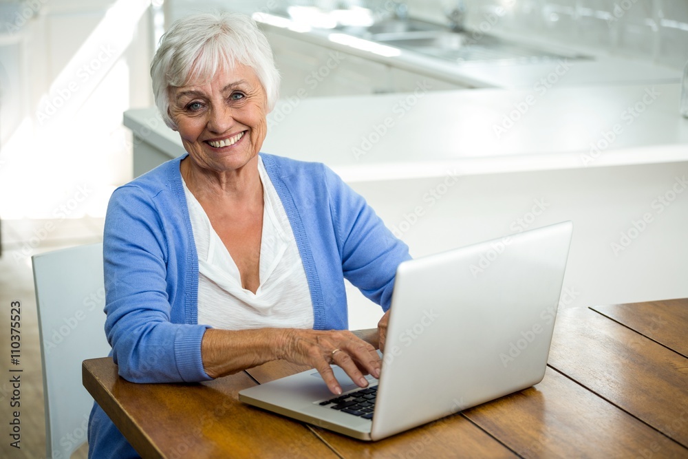 Portrait of happy senior woman using laptop Portrait of happy senior woman using laptop