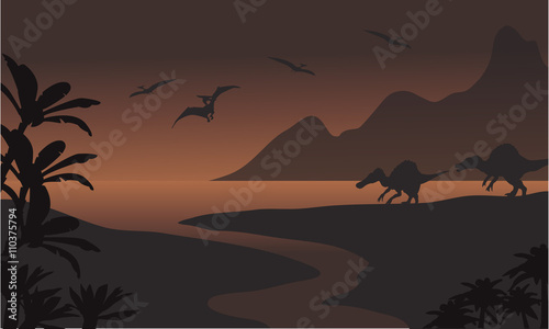 Silhouette of spinosaurus in riverbank and pterodactyl