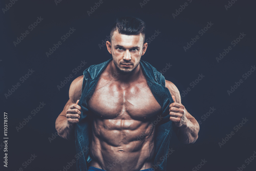 strong athletic man on black background strong athletic man on black background