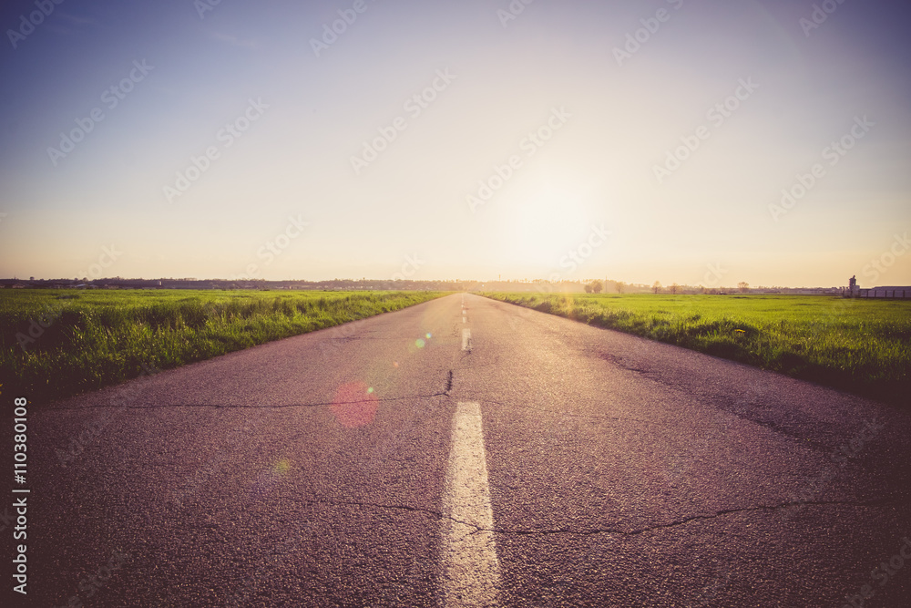 Paved road at the sunset