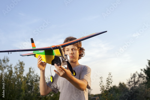 Teen with homemade radio-controlled model aircraft