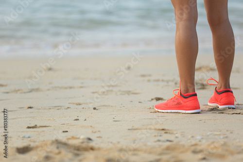 young fitness woman runner legs on beach