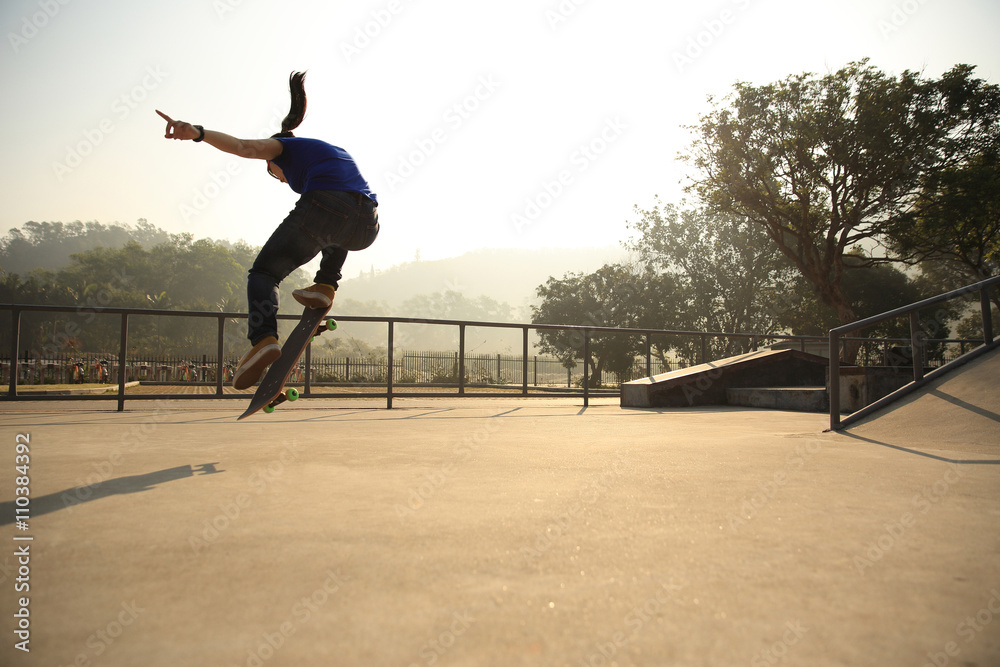 skateboarding woman practice ollie at skatepark skateboarding woman practice ollie at skatepark