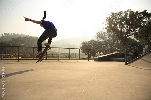 Photography skateboarding woman practice ollie at skatepark