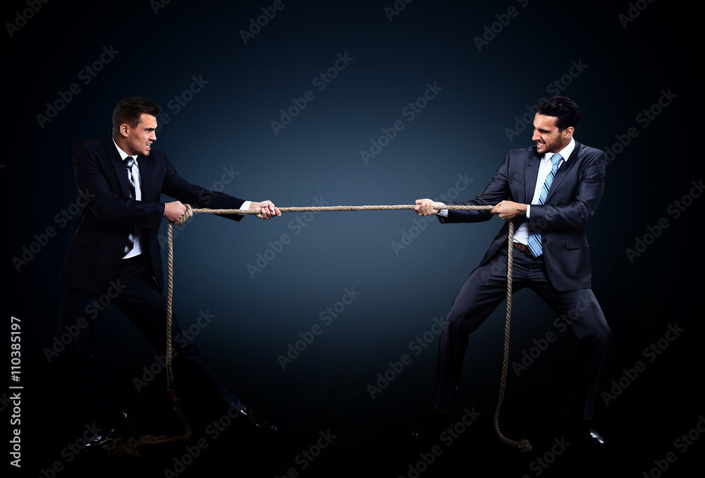 Two business men pulling rope in a competition Two business men pulling rope in a competition