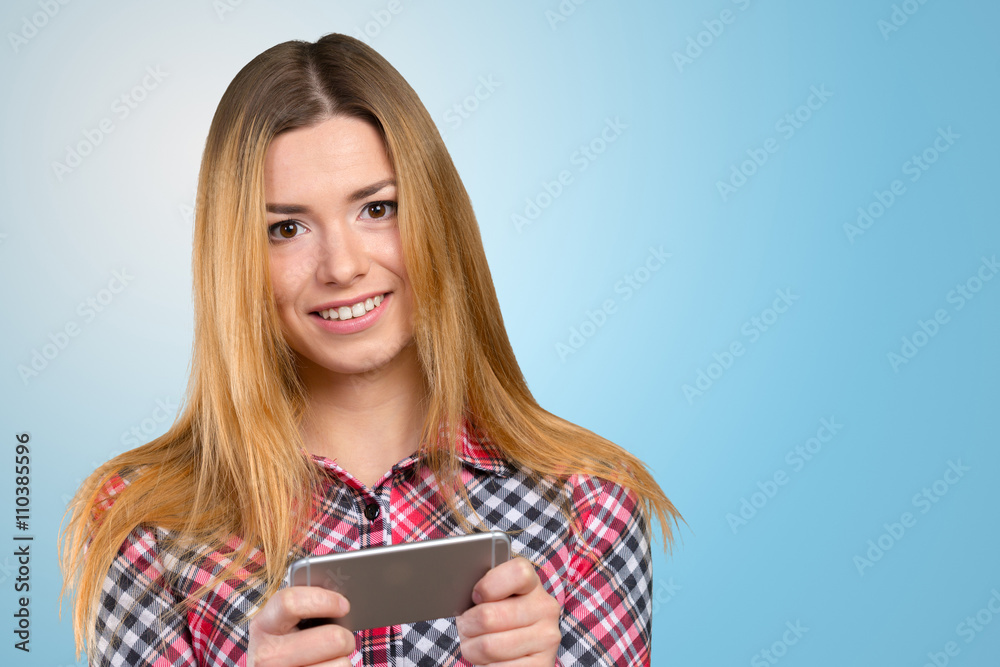 Cheerful young woman holding mobile phone Cheerful young woman holding mobile phone
