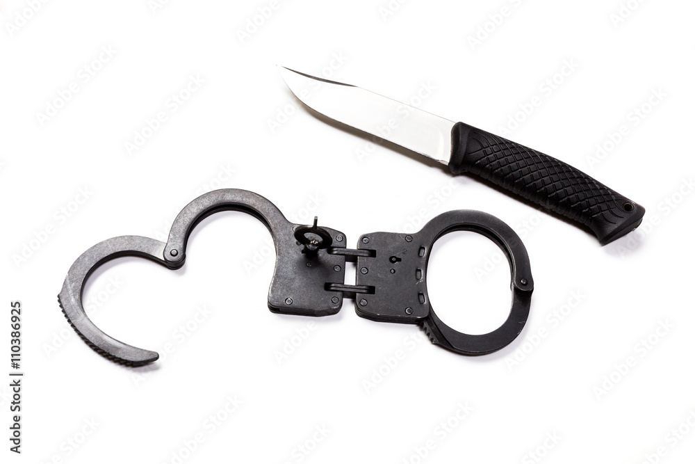 Handcuffs and knife on white isolated background Handcuffs and knife on white isolated background