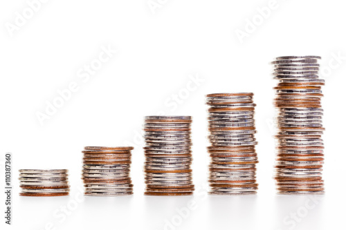 Savings, increasing columns of coins isolated on white background