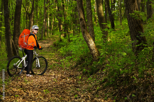 Cyclist Riding the Bike on a Trail in Summer Forest