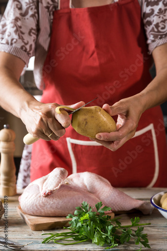 Unrecognizable woman cooking chicken