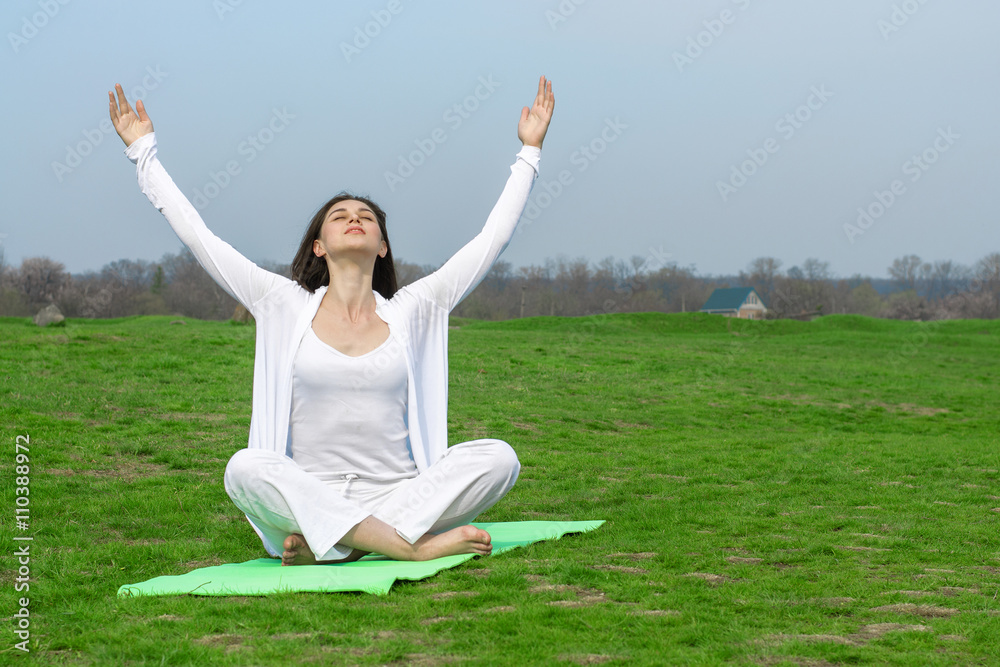 Woman in white doing yoga exercise Woman in white doing yoga exercise