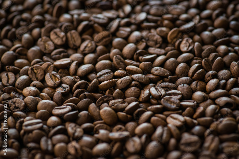 Roasted coffee beans on old wooden table Roasted coffee beans on old wooden table