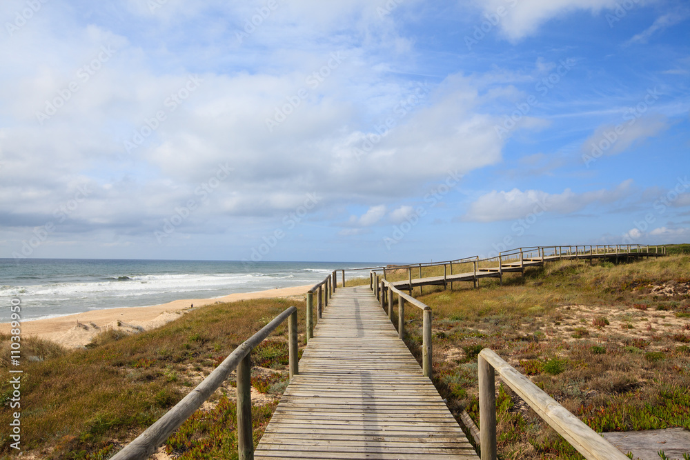 Landscape of portuguese beach with wooden walkway, Portugal