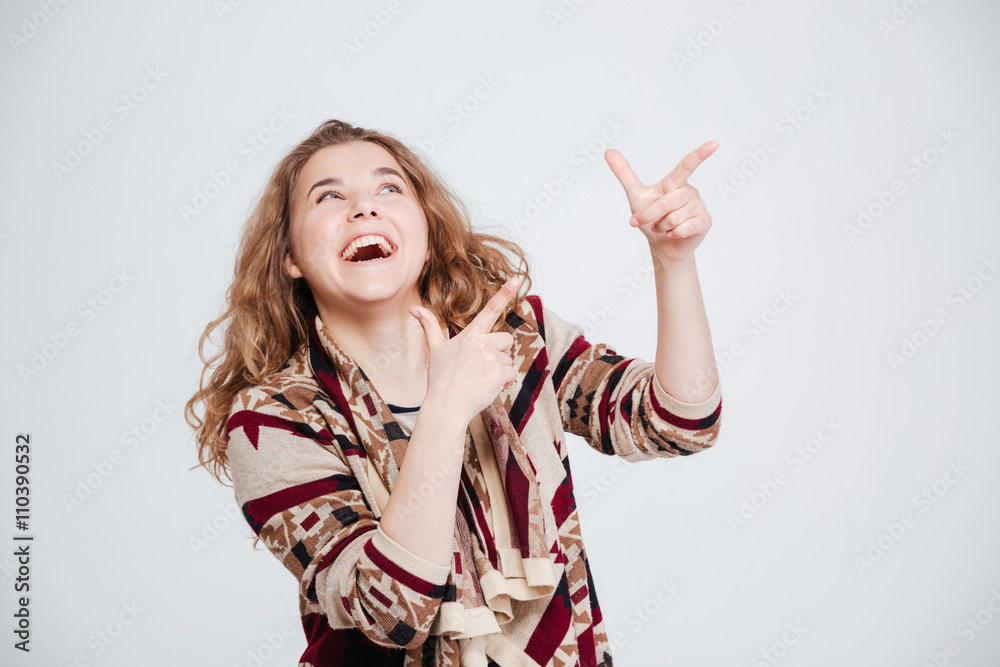 Cheerful woman pointing finger away Cheerful woman pointing finger away